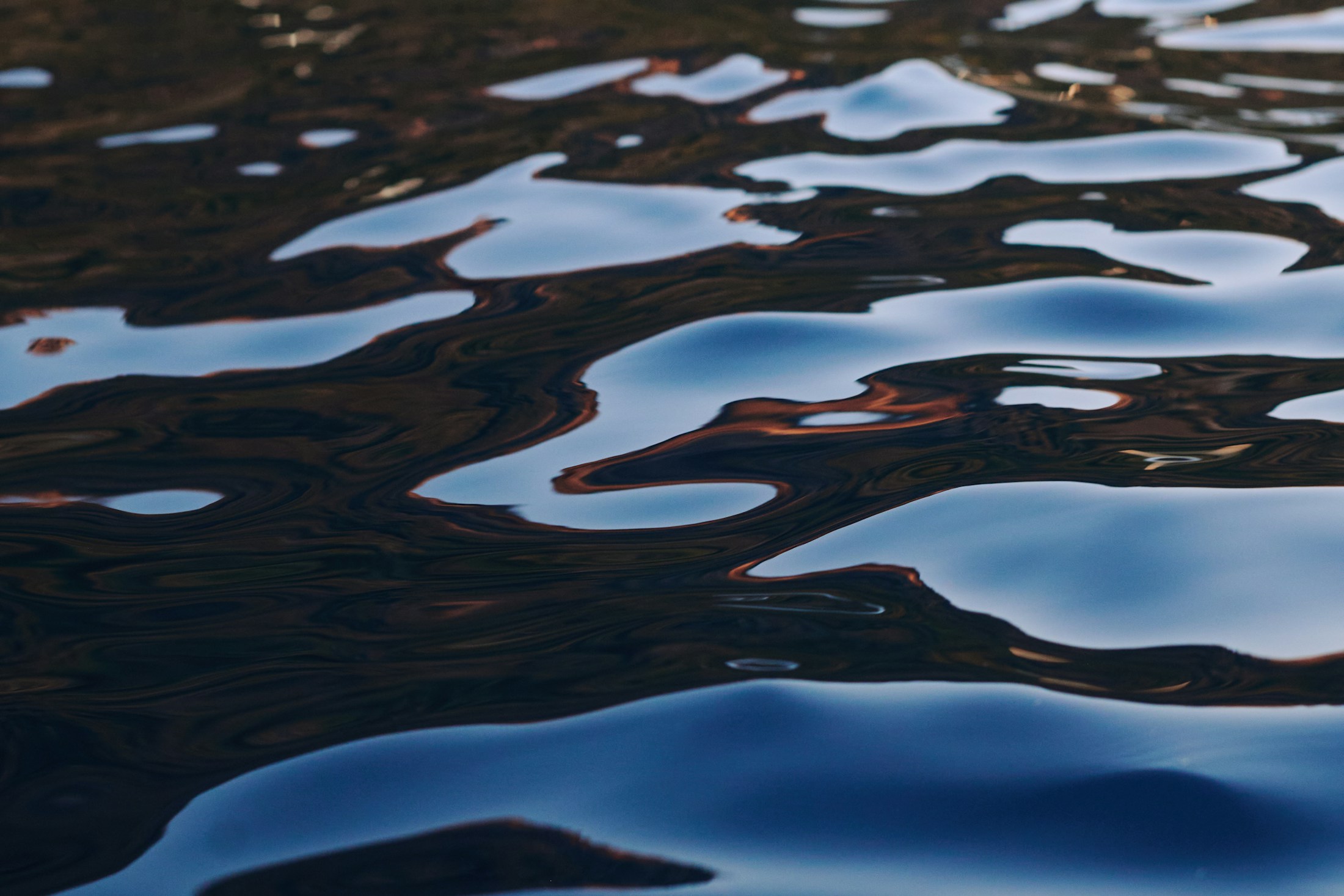 Reflections moving across dark Mediterranean water