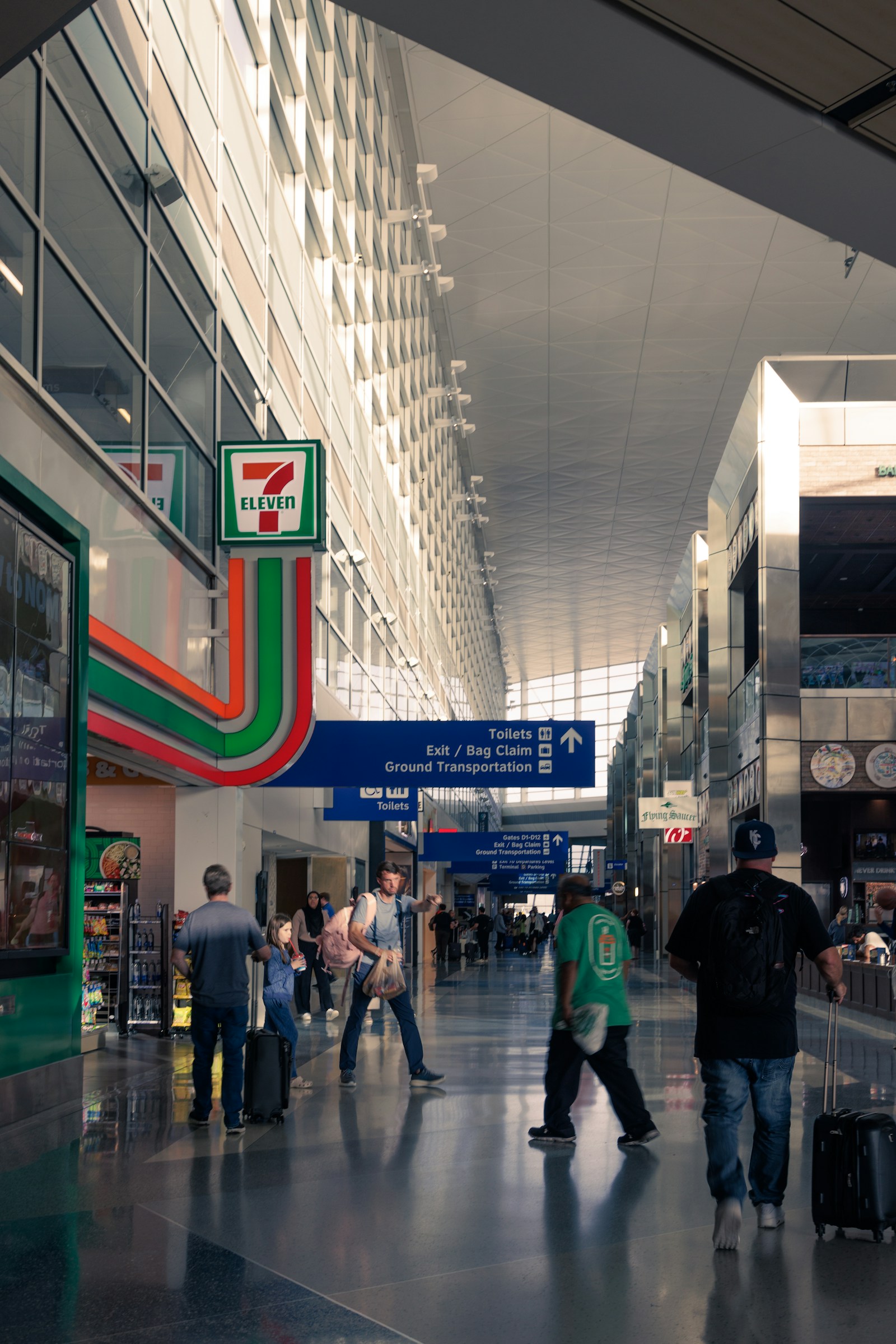 Travellers moving through expressive airport architecture